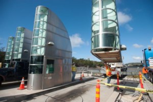 workers installing new toll lane gates on Providence Rd.