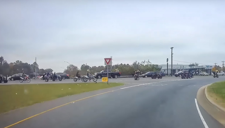 Large Group of Dirt Bike and ATV Riders Captured on Film Riding Down Charlotte Streets