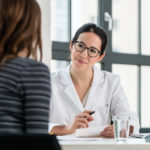 Female physician listening to her patient during consultation