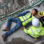 Check Response and pulse, Life-saving, and rescue methods. Builder accident falls scaffolding on floor, Safety team helps employee accident. First aid support accident in Construction work.