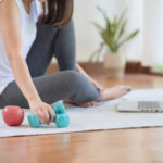 Asian woman staying fit by exercising at home for healthy trend lifestyle