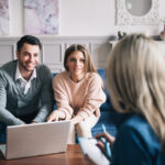 Real-estate agent shows a build project to a young couple.
